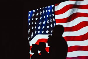 silhouette of people beside usa flag